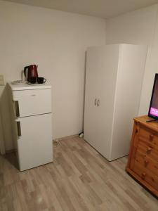 a room with two white refrigerators in a room at ferieninpyrmont in Bad Pyrmont