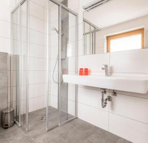 a bathroom with a sink and a shower at Schartlhof in Flachau +63 photos