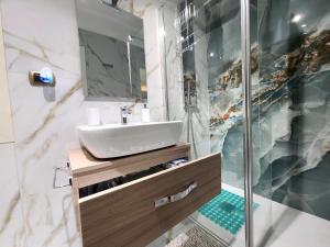 a bathroom with a sink and a shower at la casa di patta a spaccanapoli in Naples +44 photos