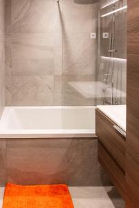 a bathroom with a shower and a tub and a sink at Samoëns Apartment 2 bedroom 50m2 modern and well equipt in Samoëns