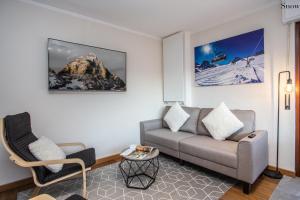 a living room with a couch and a chair at Apartments Les Crouses in Valtournenche +76 photos