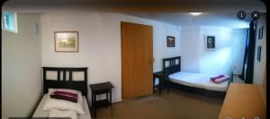 a small room with two beds and a door at "Elbparadies" Ferienhaus am Niegripper See mit Pool in Burg bei Magdeburg +19 photos