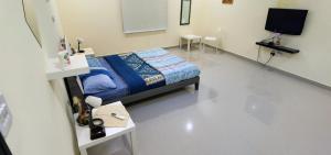 a hospital room with a bed and a tv at إستراحة شاطئ الشمال North Beach Resort in Ar Ruʼays