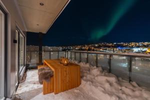 an enchanting view of the aurora from the balcony of a house at Premium Penthouse Sea & Mountain view Apartments in Tromsø in Tromsø