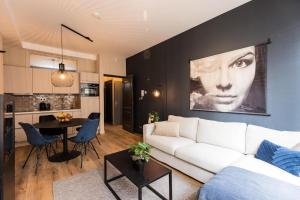 a living room with a white couch and a table at Haya Historic - Viognier in The Hague
