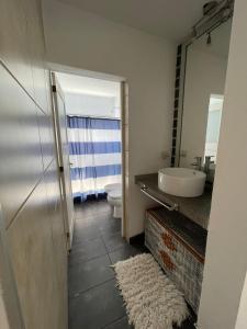 a bathroom with a sink and a toilet and a mirror at Casa Rumipal in Villa Rumipal +8 photos