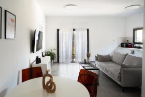 a living room with a couch and a table at Haim Arlosoroff Residence - MAMAD in Tel Aviv