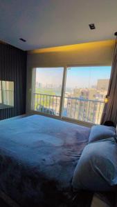 a bedroom with a bed and a large window at إشراقة النيل in Cairo