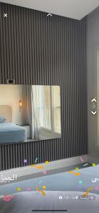 a bedroom with a bed and a large mirror at إشراقة النيل in Cairo