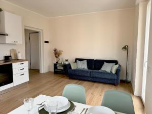 a living room with a couch and a table and chairs at Fiore di Lago in Colico