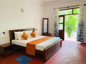 a bedroom with a bed and a large window at Villa Ocean Whisper in Bentota
