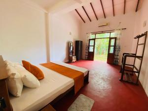 a bedroom with two beds and a large window at Villa Ocean Whisper in Induruwa