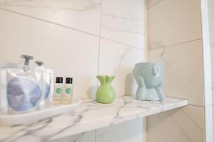 two vases sitting on a shelf in a bathroom at Merchants Rest in Galway