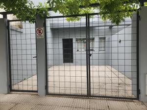 an open gate with a room in a building at Duplex en Gualeguay in Gualeguay