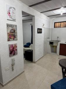 a room with a bathroom with a sink and a table at Acogedor Aparta estudio central in Popayan