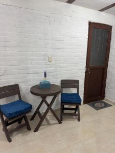 a table and two chairs with a cake on it at Acogedor Aparta estudio central in Popayan