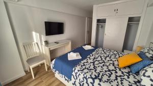 a bedroom with a bed and a desk and a television at Blue Oasis Sea and Mountain Panorama in Benalmádena +20 photos