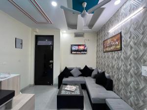 a living room with a couch and a ceiling fan at Hotel Silver Inn in Noida