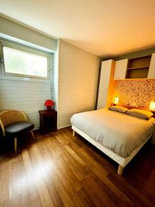 a bedroom with a bed and a window at Le Mouette - Seaside in La Rochelle