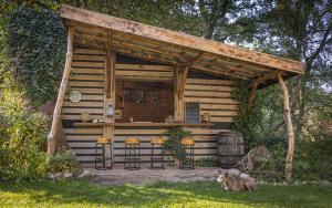 a log cabin with a bar in the yard at Baumhaus Beletage in Bockhop +52 photos