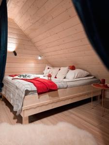 a bed in a room with a wooden ceiling at Góralska Chata in Czarna Góra