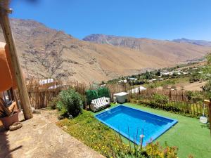 a swimming pool in a yard with a mountain in the background at Domo Sol Del Valle in Horcon