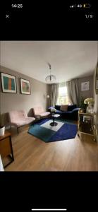a living room with a couch and a rug at Cute apartment in London