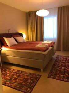 a bedroom with a large bed and a window at Premium City Center 2 rooms Apartment Glassed Balcony FREE PRIVATE PARKING in Kemi