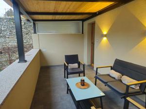 a living room with two chairs and a table at RNR Apartments in Buzet