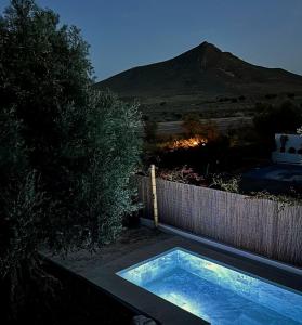 a swimming pool with a mountain in the background at Villa Filon in Rodalquilar