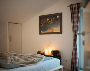 a bedroom with a bed and a picture on the wall at Schwalbennest Velden in Velden am Wörthersee