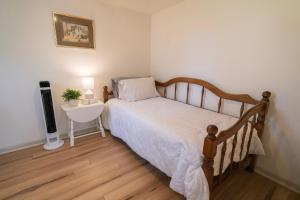 a bedroom with a bed and a table and a lamp at Hadley Hideaway Cottage in Hadley +3 photos