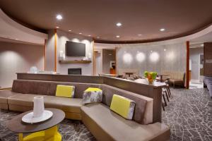 a living room with couches and a television in a room at SpringHill Suites Thatcher in Thatcher