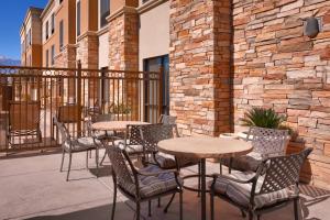 a group of tables and chairs on a patio at SpringHill Suites Thatcher in Thatcher