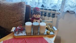 a tray with a snowman and candles on a table at Vikendica Mašan in Pale +6 photos