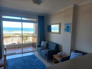a living room with a couch and a view of the ocean at 215 Sea View in Cape Town
