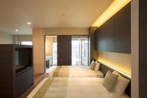 Postel nebo postele na pokoji v ubytování Hotel Keihan Kyoto Grande