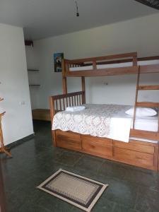 a bedroom with two bunk beds and a rug at Pousada da Praia II in Guarujá