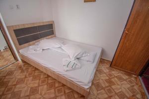 a bed with white sheets and pillows in a room at La David Straja in Straja +47 photos