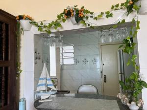 a room with a table with a model boat on the wall at Vista Incrível para o MAR com 3 Quartos in São Vicente +55 photos