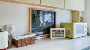a living room with a microwave and a tv at HELIOS ApArt Hotel - DeLuxe Residence, close to the city CENTER in Timişoara