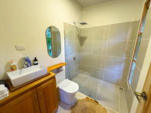 a bathroom with a shower and a toilet and a sink at Quintaesencia Arte y Naturaleza in Guápiles +21 photos
