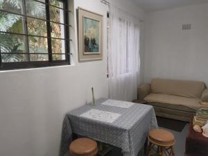 a living room with a table and a couch at Bush Cottage in Pennington