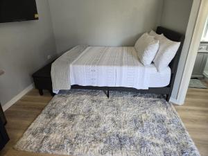 a small bedroom with a bed with a rug at Sunburst Studio in Turtle Cove