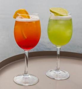 three cocktails sitting on a table with at Oikos Sani Suites in Sani Beach