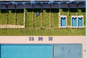 an overhead view of a building with a yard at Oikos Sani Suites in Sani Beach