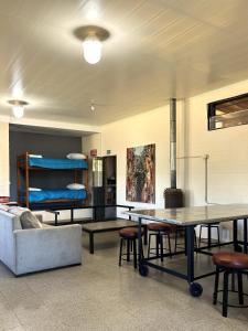 a room with a table and a couch and bunk beds at La Fabrica in Yacanto