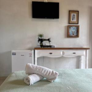 a rolled up towel sitting on top of a bed at Pousada Lagoa do Rosa in Praia do Rosa +77 photos