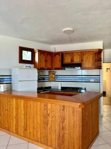 a large kitchen with wooden cabinets and a counter top at Mangos Mar D in Puerto Naos