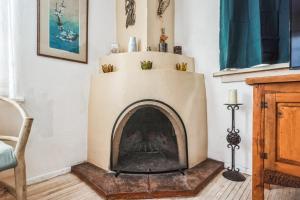 a fireplace in a living room with a chair at Famed Plaza Oasis 1 mile away, King Bed, Office, Foosball in Santa Fe